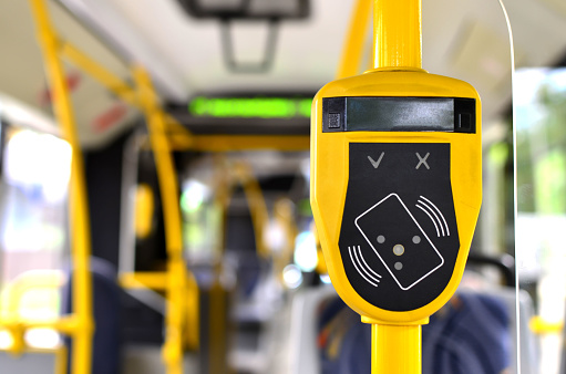 Automatic validator for reading and scanning ticket, cards and bank cards in public transport to pay for riding. Wireless contactless cashless payments, rfid nfc.