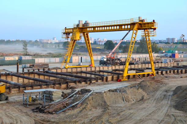 istock Gantry crane and auto crane working at construction site. Digging a pit for the building of an underground tunnel of the metro line. Subway construction project, Minsk, Belarus, Aerodromnaya street 1210549791