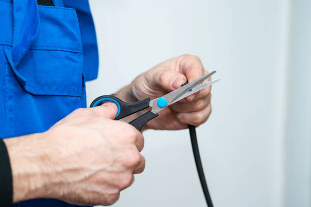istock Professional window repair and installation technician, cuts sealing rubber for installation in a pvc window 1210550996