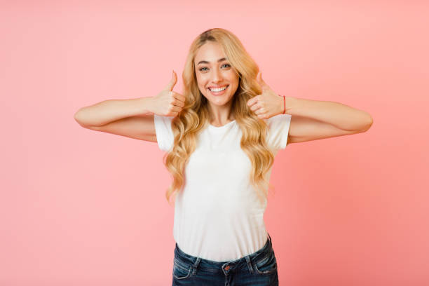 istock Like it. Pretty girl showing thumbs up with both hands 1210551446