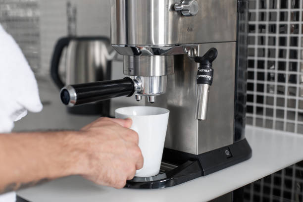 istock Guy prepare delicious aromatic coffee in a coffee machine. A simple way to make coffee 1210551672