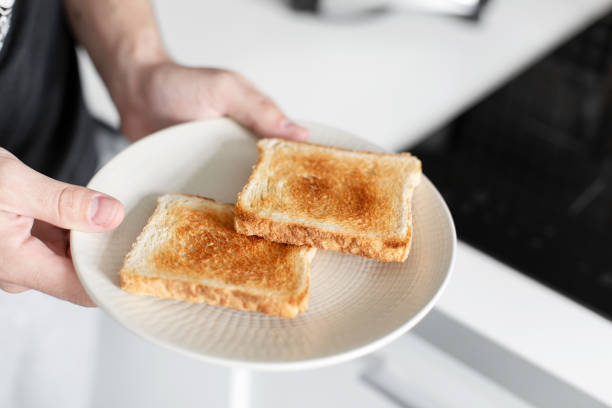 istock The guy has breakfast with toast with jam. 1210551690