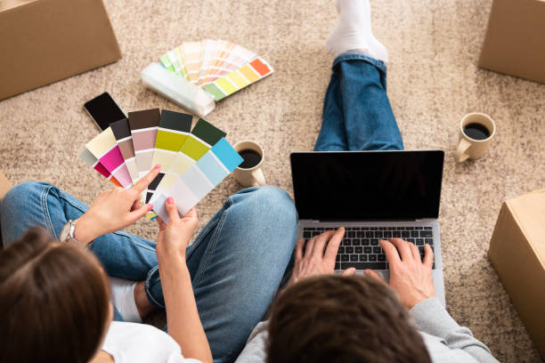 istock Unrecognizable young couple with laptop choosing color 1210551699