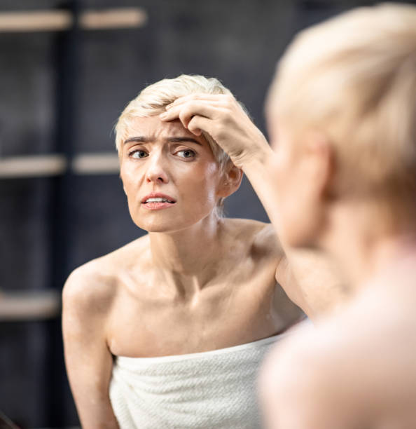 istock Concerned Lady Looking At Wrinkles Standing In Bathroom Indoor 1210552658