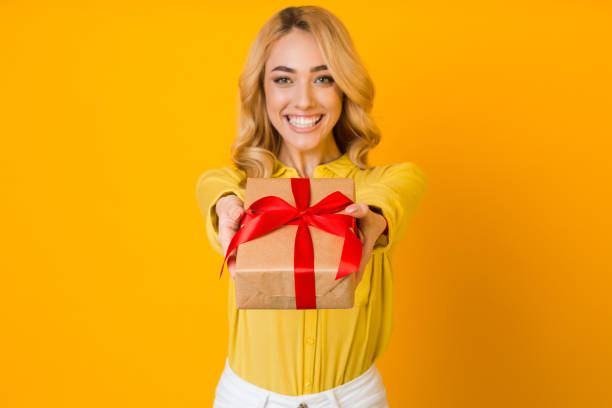 istock Pleasant gift. Woman stretching present box to camera 1210553126