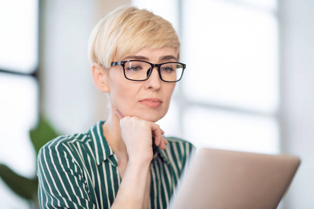 istock Entrepreneur Lady Using Tablet Reading News Sitting At Workplace Indoor 1210553416