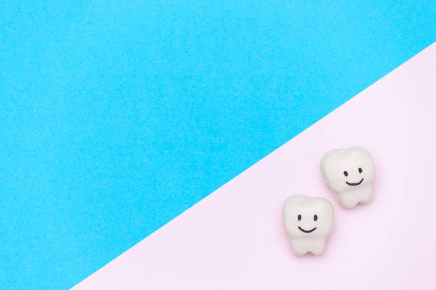 istock White smiled tooth, space for text on color background. Healthy dental teeth concept. 1210554372