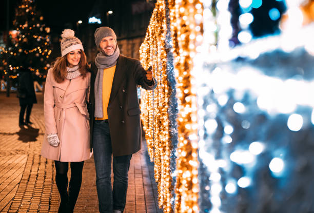 istock Loving couple while walking between Christmas decorations on the street 1210555101