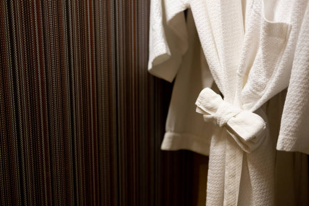 istock Soft comfortable bathrobes hanging on rack in closet in hotel 1210555183