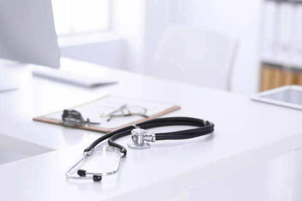 istock Stethoscope, prescription medical form lying on a table with pc computer. Medicine or pharmacy concept. Medical tools at doctor working table 1210557085