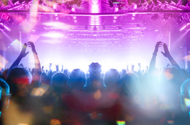 istock Concert stage, people are visible waving and clapping, silhouettes are visible 1210558989
