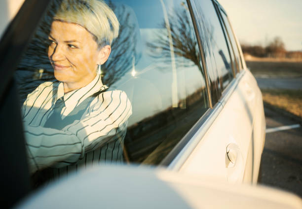 istock Smiling woman in a car 1210559297