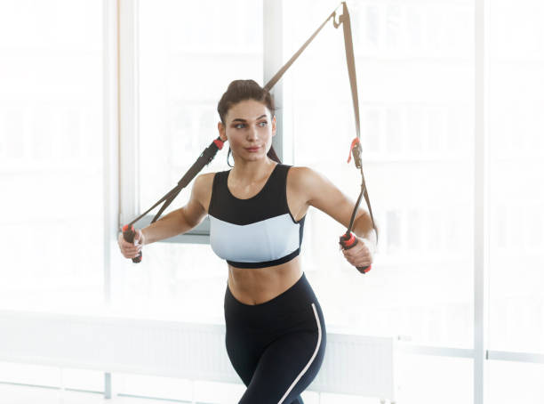 istock Young woman working out on cable machine in gym 1210559482
