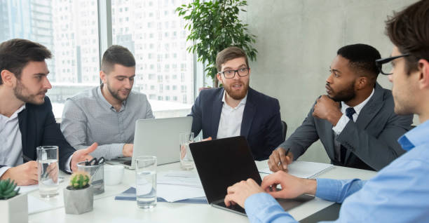 istock Business group having morning briefing in office 1210560598