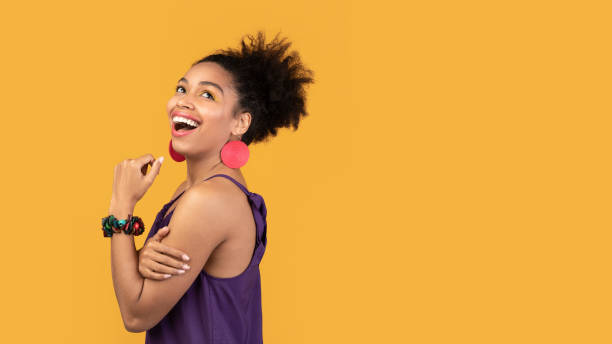 istock Smiling black woman looking up at studio 1210561060
