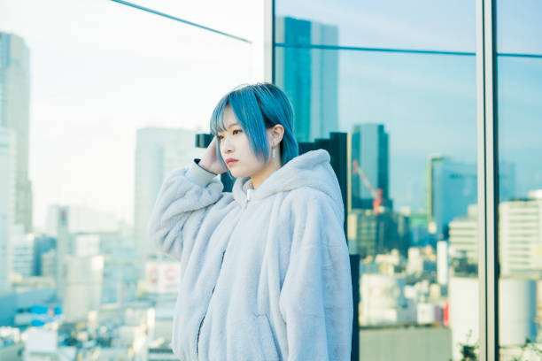 istock Young woman with blue hair 1210561085