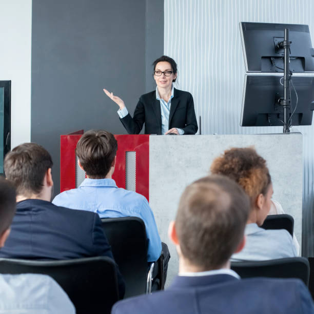 istock Confident CEO giving presentation to young staff 1210561128