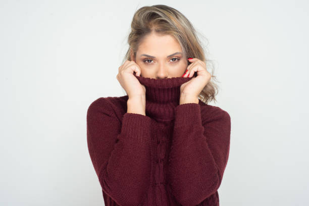 istock Young woman in turtleneck looking at camera 1210561141