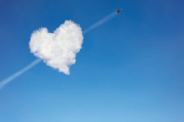 istock Airplane passing through the heart shaped cloud 1210561329