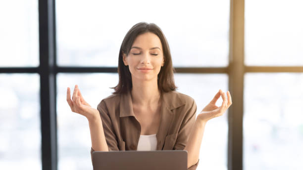 istock Girl meditating in office coping with stress at workplace 1210561524