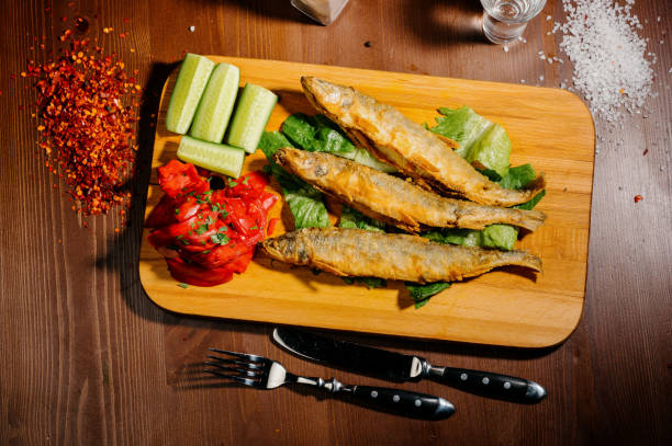 istock Fish dish - fried fish fillet with vegetables.Top view 1210561728