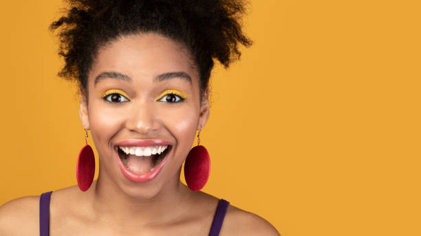 istock Happy afro woman screaming looking at camera 1210562489