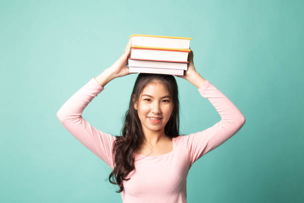istock Young Asian woman studying  with may books. 1210562696
