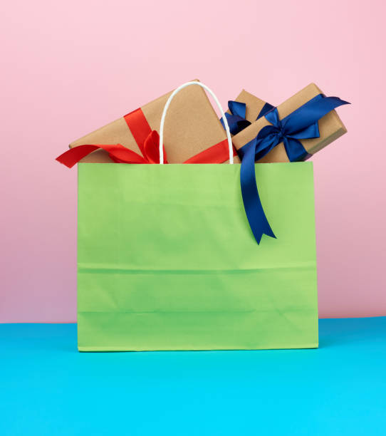 istock pink paper bag with a gift box 1210562910
