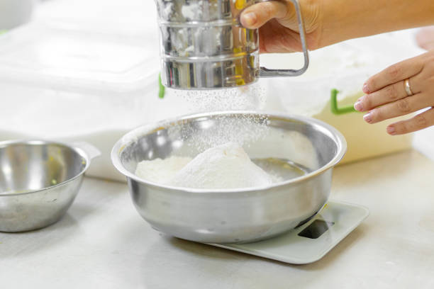 istock Cooking Baking. Cook sifts the flour a 1210563965