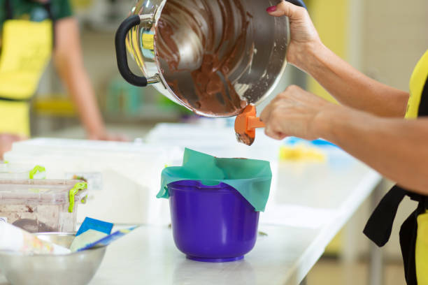 woman professional pastry chef prepares chocolate dough. - chef cookie dishware domestic kitchen imagens e fotografias de stock