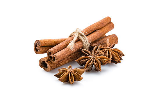 Aromatherapy: cinnamon sticks and star anise isolated on white background. Predominant colors are orange, brown and white. High resolution 42Mp studio digital capture taken with Sony A7rII and Sony FE 90mm f2.8 macro G OSS lens