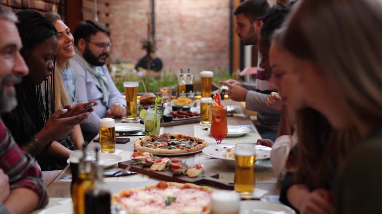 Diverse group of people eating outdoors in pub