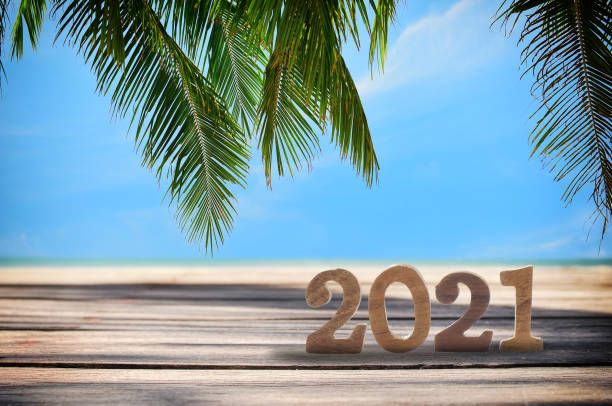 istock Wood number 2021 on planks on tropical beach background 1210565986