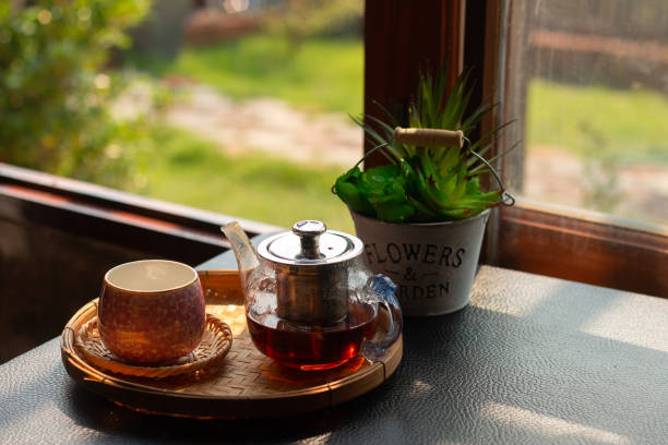 istock A cup of hot tea on the wooden table. 1210566157