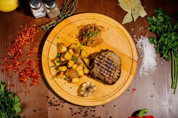 istock fried potatoes with meat on a plate on a wooden table.Top view 1210566912