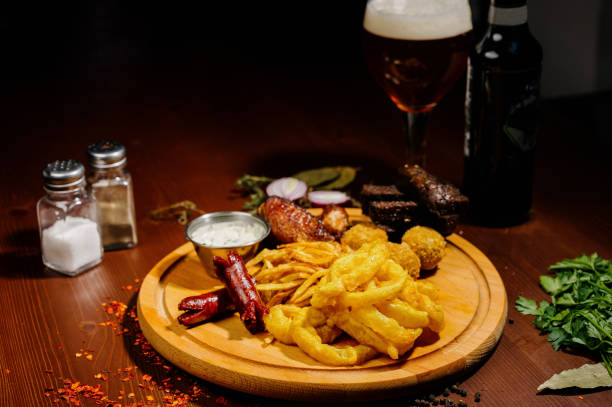 istock Selection of beer and snacks.Chips, fish, beer sausages on the table 1210568919