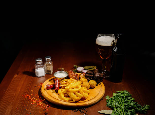 istock Selection of beer and snacks.Chips, fish, beer sausages on the table 1210568938