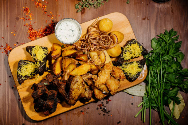 istock Selection of beer and snacks.Chips, fish, beer sausages on the table.Top view 1210568952
