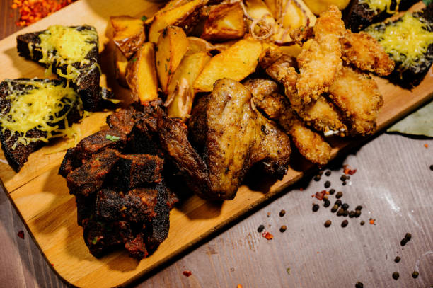 istock Selection of beer and snacks.Chips, fish, beer sausages on the table 1210568954