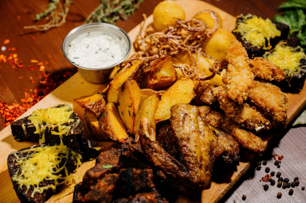 istock Selection of beer and snacks.Chips, fish, beer sausages on the table 1210568960