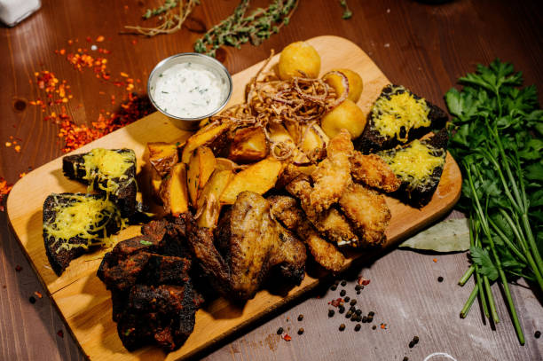 istock Selection of beer and snacks.Chips, fish, beer sausages on the table 1210568965