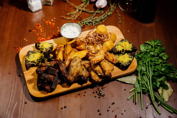 istock Selection of beer and snacks.Chips, fish, beer sausages on the table 1210568971