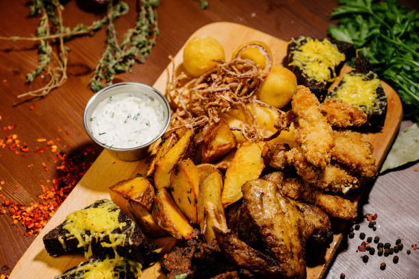 istock Selection of beer and snacks.Chips, fish, beer sausages on the table 1210568973