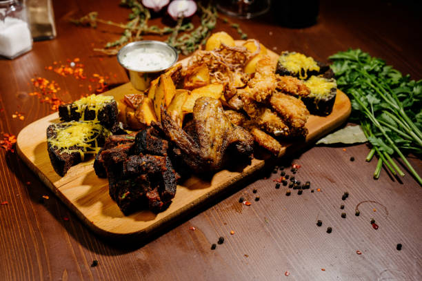 istock Selection of beer and snacks.Chips, fish, beer sausages on the table 1210568988