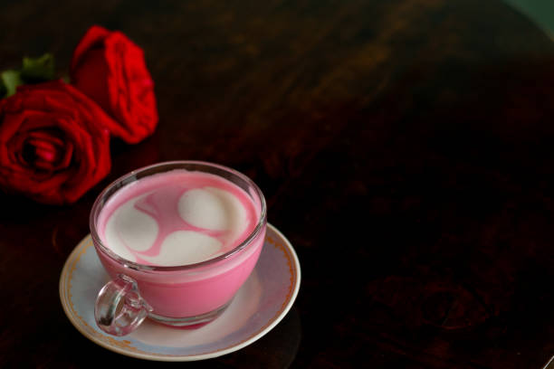 istock Pink latte on wooden table textured background. Top view. 1210569027