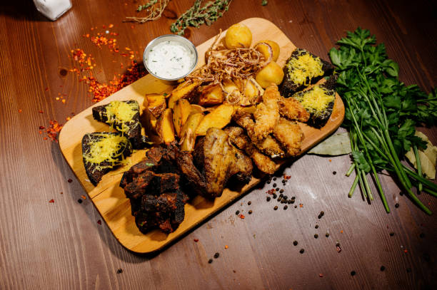 istock Selection of beer and snacks.Chips, fish, beer sausages on the table 1210569178