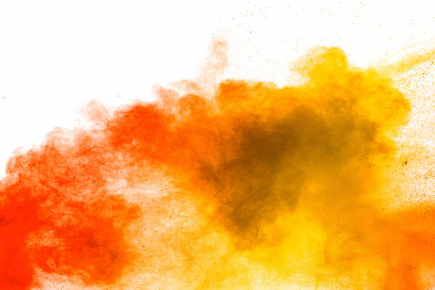 istock Red yellow  powder explosion on white background.Red yellow color dust splash clouds. 1210569471