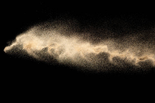 istock Brown colored sand splash.Dry river sand explosion isolated on black background. Abstract sand cloud. 1210569584