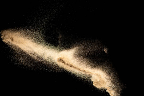 istock Brown colored sand splash.Dry river sand explosion isolated on black background. Abstract sand cloud. 1210569588