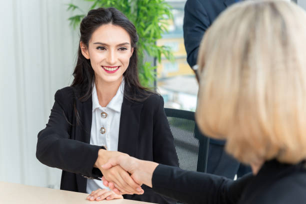 istock Businesswoman shaking hands with smile 1210570718